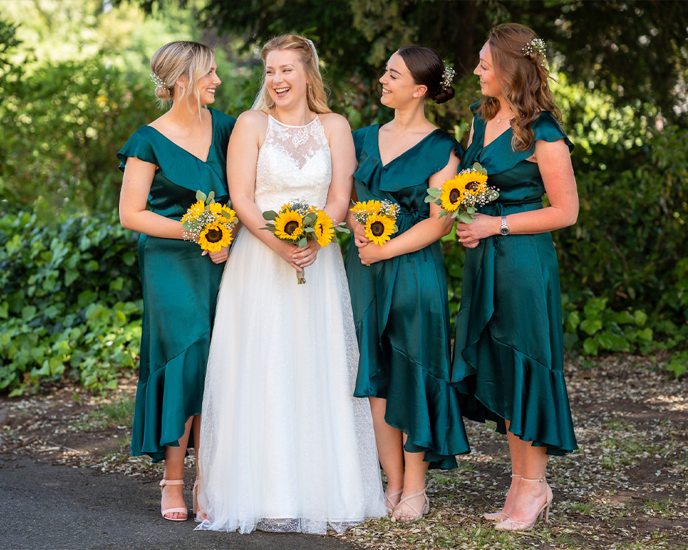 Bride and Bridemaids laughing. Exeter, Devon.