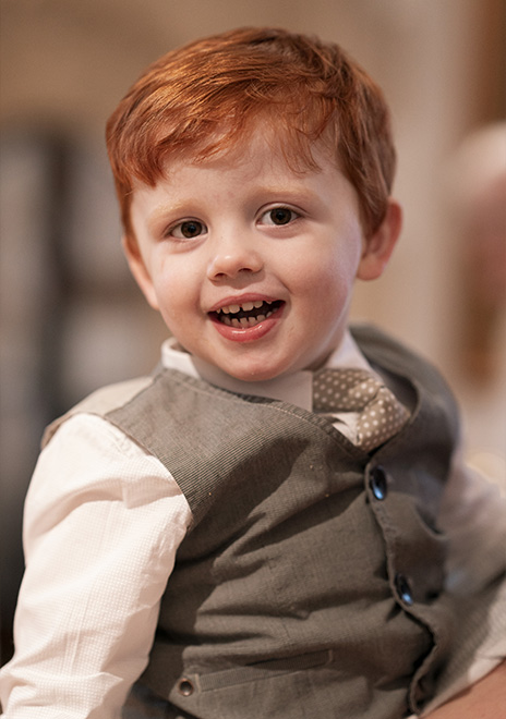 Boy smiling at Christening at St Mary's Church in Torquay.