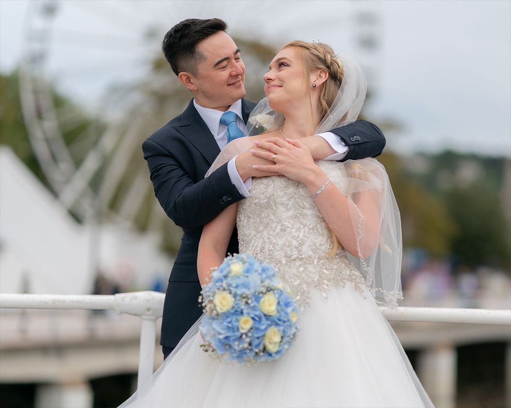 Bride and Groom photo with Big Wheel behind in Torquay.