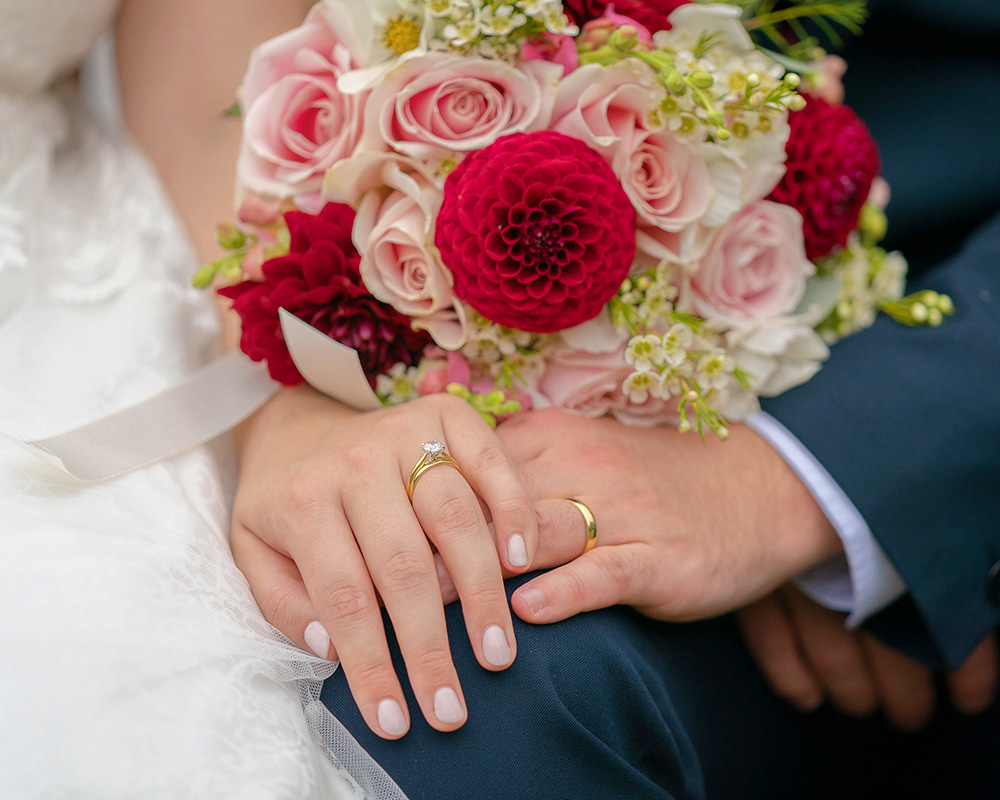 Wedding rings and wedding bouquet.