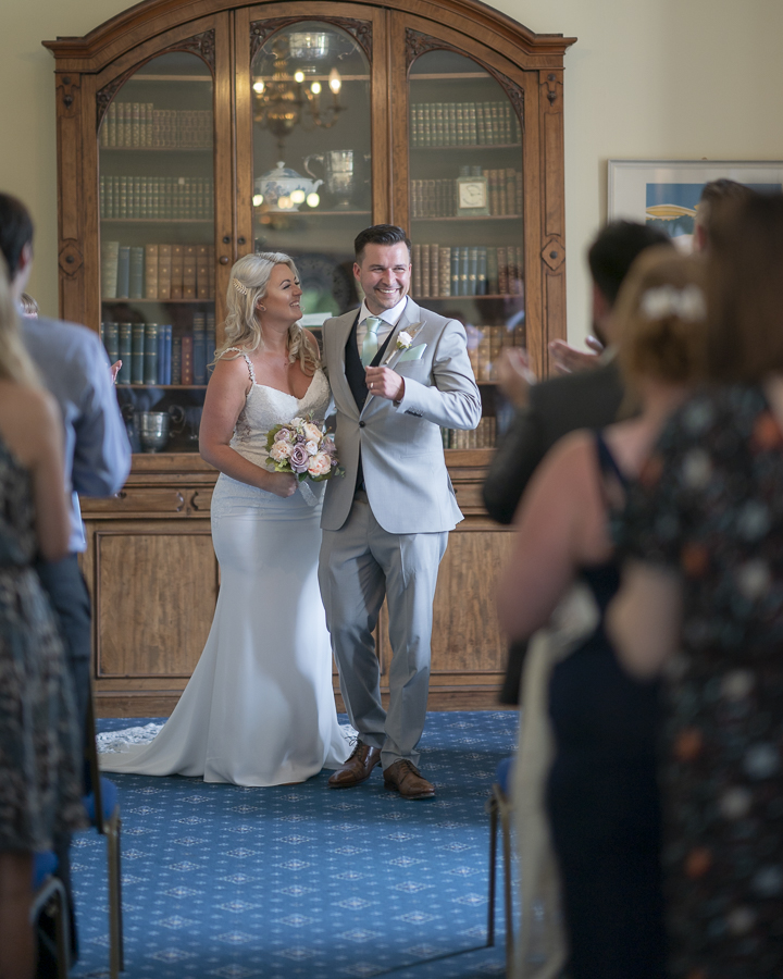 Bride and Groom walking down the aisle at their Wedding at Larkbeare House, Exeter, Devon.