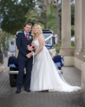 Wedding couple by vintage wedding car at Exeter golf and country club.