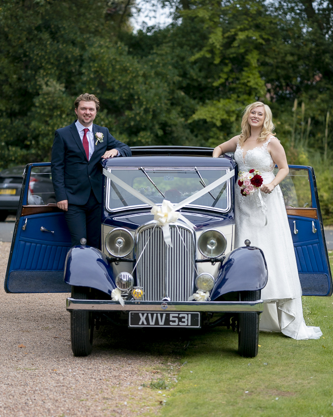 Newly weds by vintage wedding car, a Rover