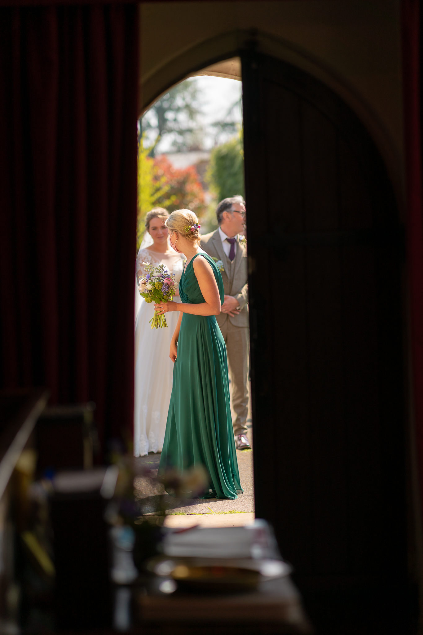 Bridesmaid through the church doors