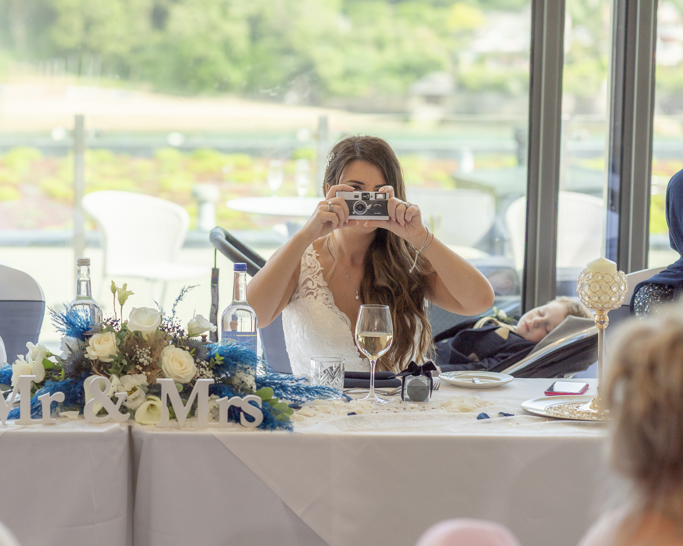 Bride taking a photo of me, the wedding photographer