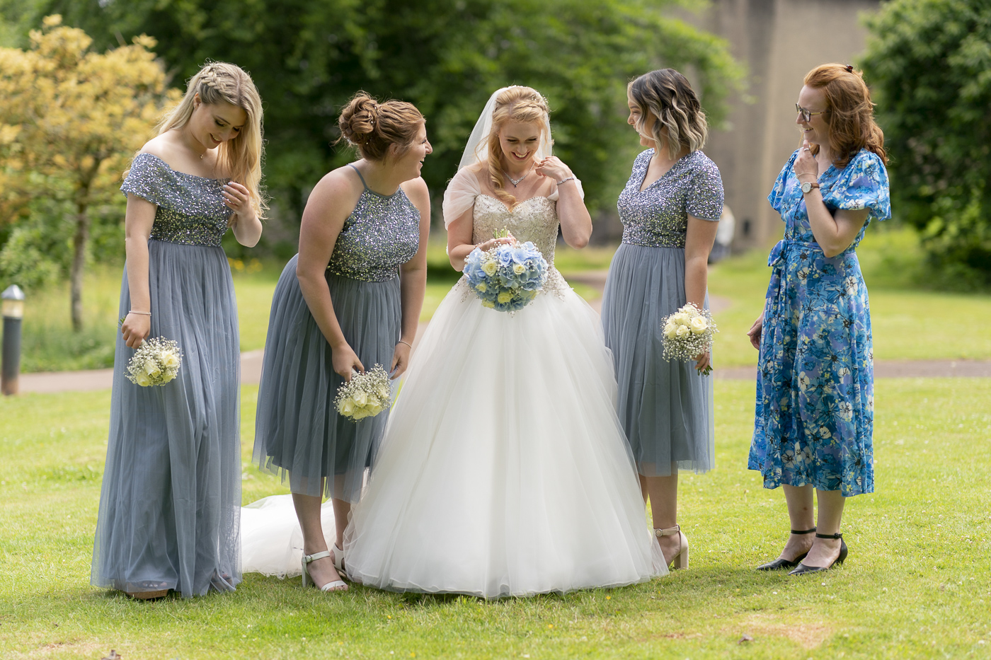 Bride with bridesmaids laughing and joking