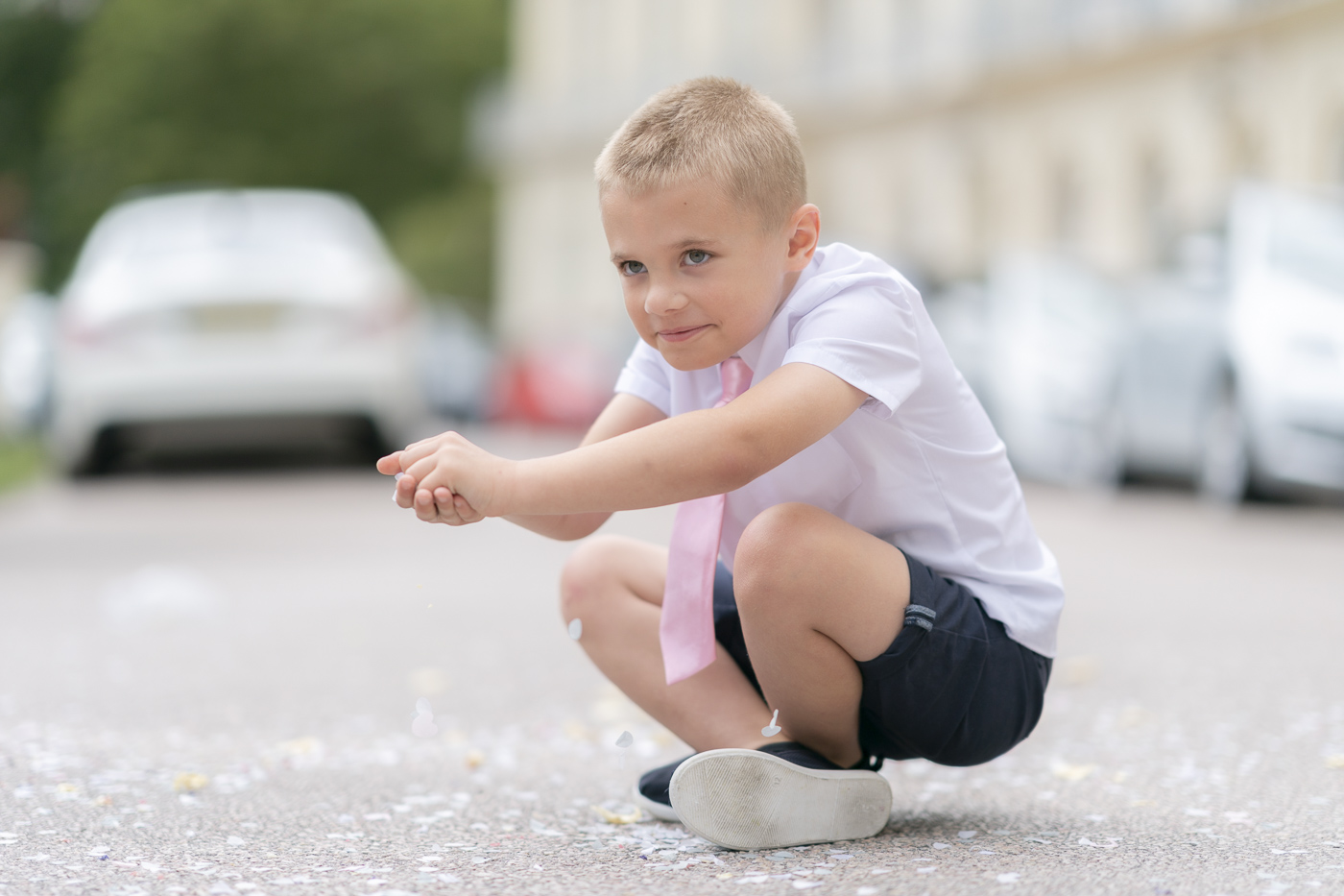 Boy gathering up the confetti from the floor